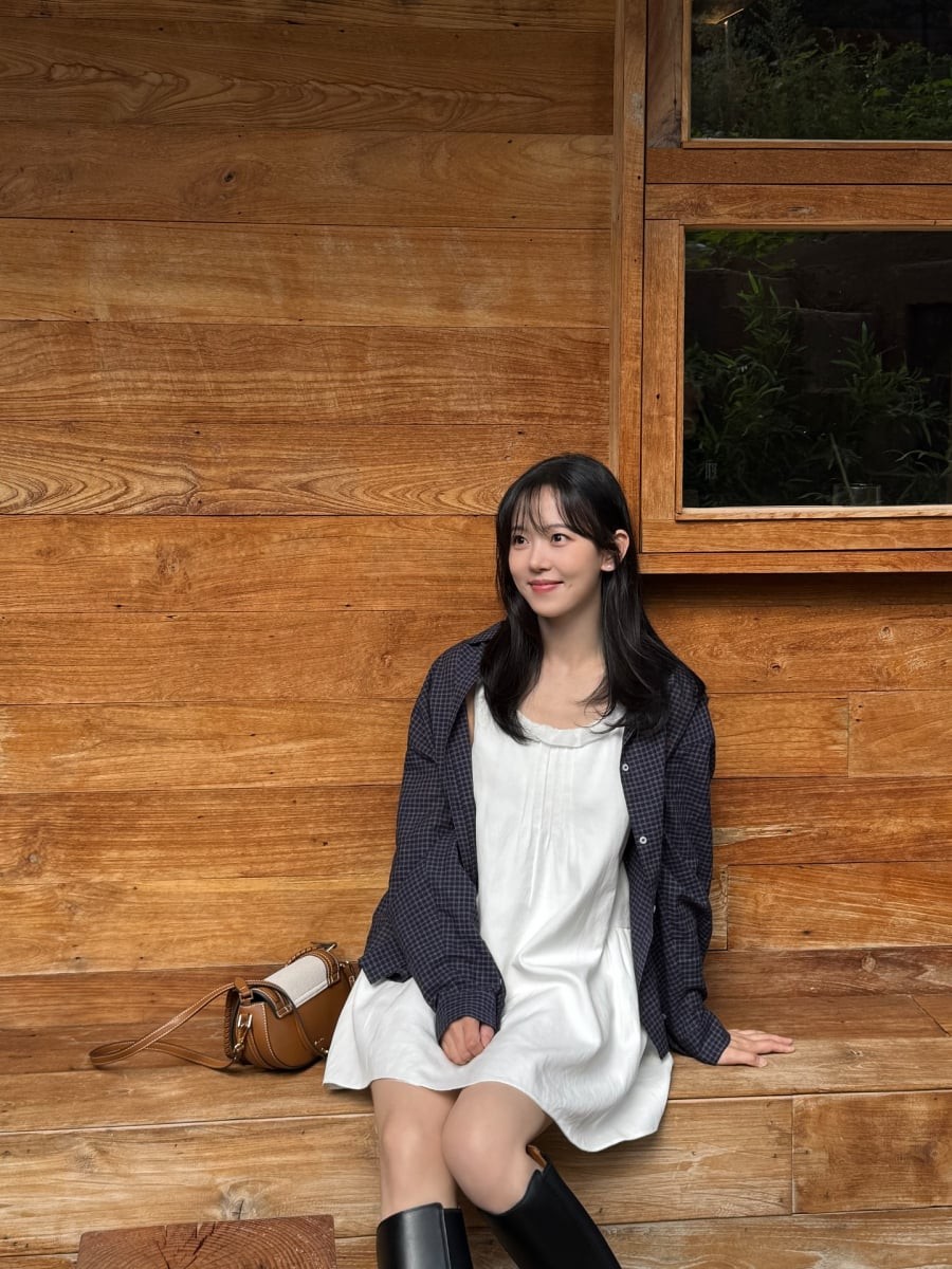 Điểm nhấn nằm ở đôi boots cao cổ, mang đến sự cân bằng giữa nét nữ tính và tinh thần thời trang hiện đại, giúp outfit không bị quá “bánh bèo”