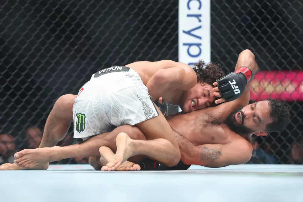 Raul Rosas Jr. of Mexico grapples with Rob Font of Puerto Rico during their bantamweight bout at T-Mobile Arena