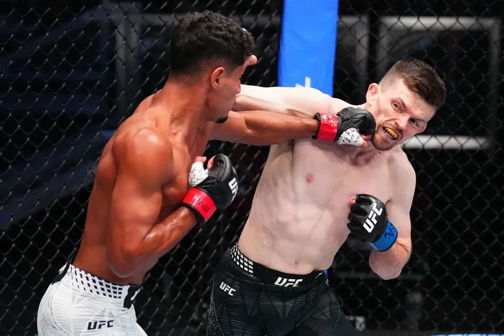 Marwan Rahiki of Morocco punches Harry Hardwick of England in a featherweight fight during the UFC Fight Night