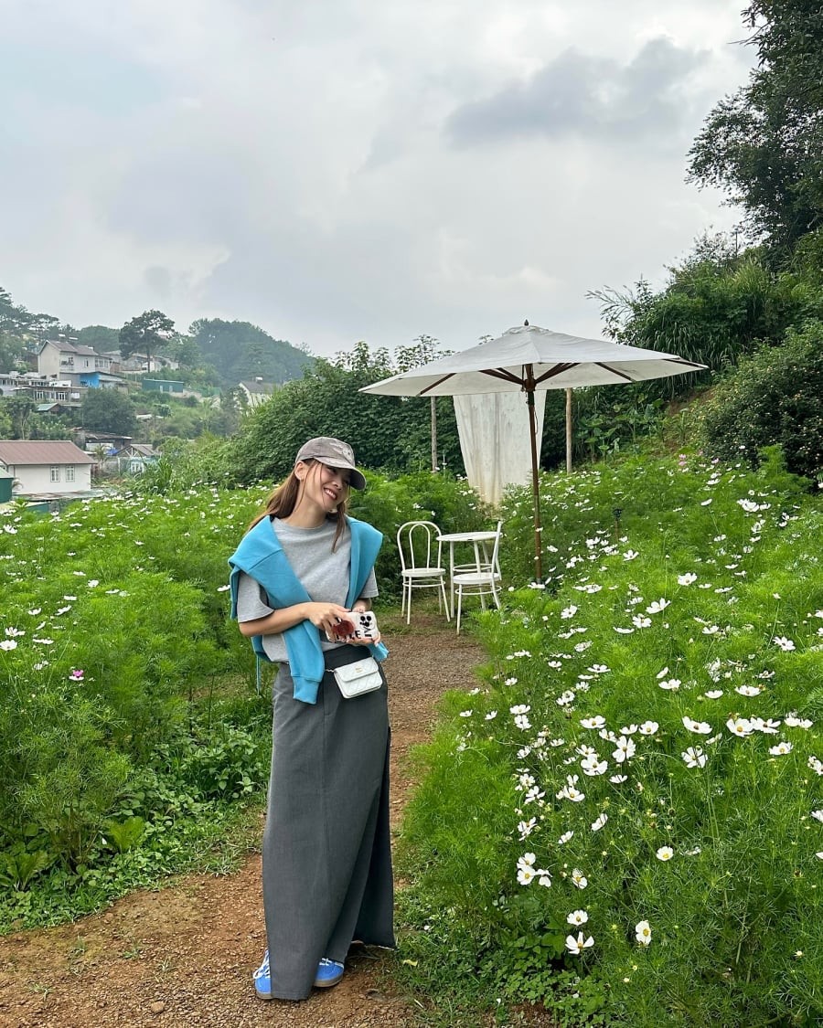 Sự kết hợp giữa áo thun xám và chân váy suông dài tạo nên diện mạo hiện đại nhưng không kém phần nữ tính. 