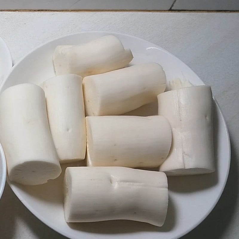 Sắn mua về bóc sạch vỏ nâu và lớp vỏ lụa bên trong, cắt bỏ hai đầu rồi rửa nhiều lần với nước cho thật sạch
