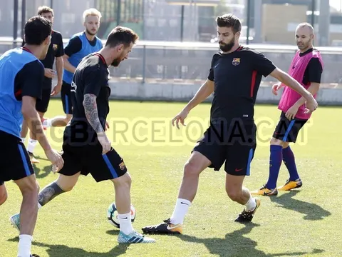 Pique thách thức Messi trên sân tập